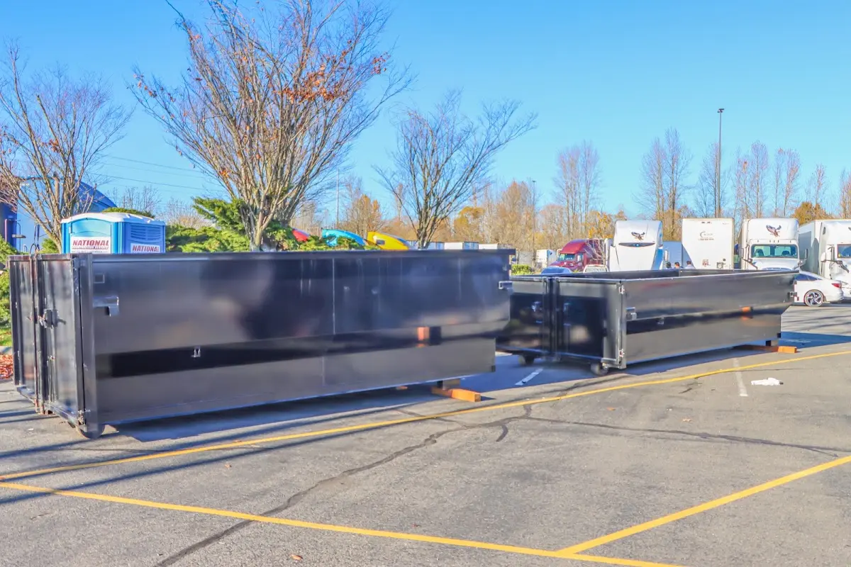 Professional dumpster rental service with roll-off container on residential driveway in Cloverly